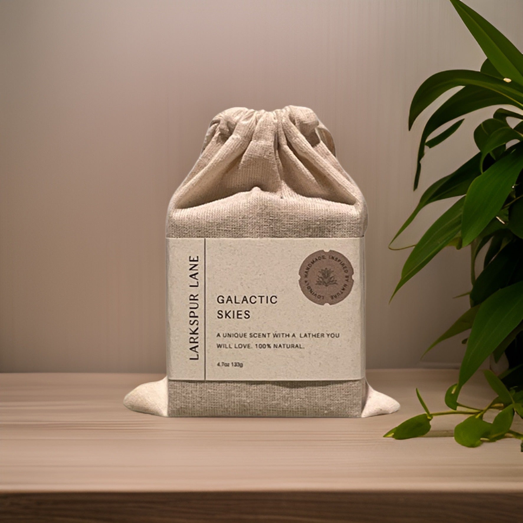 a soap in a linen bag with a paper label wrap on a bathroom counter