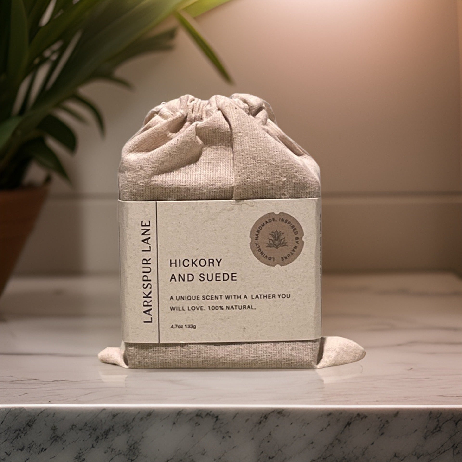 a soap in a linen bag with a recyclable paper wrap sitting on a counter
