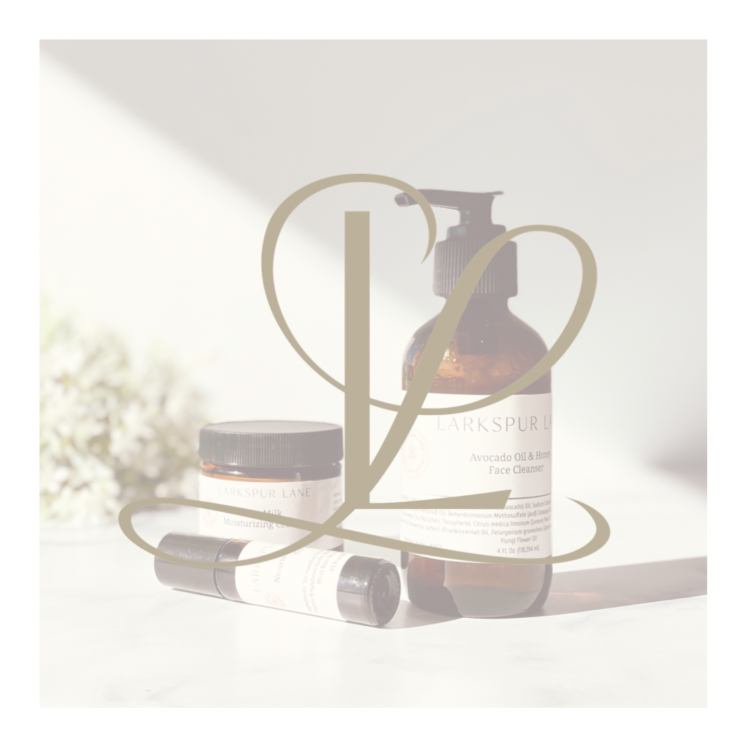 a bottle of lotion, a jar of face cream and cuticle oil on a table