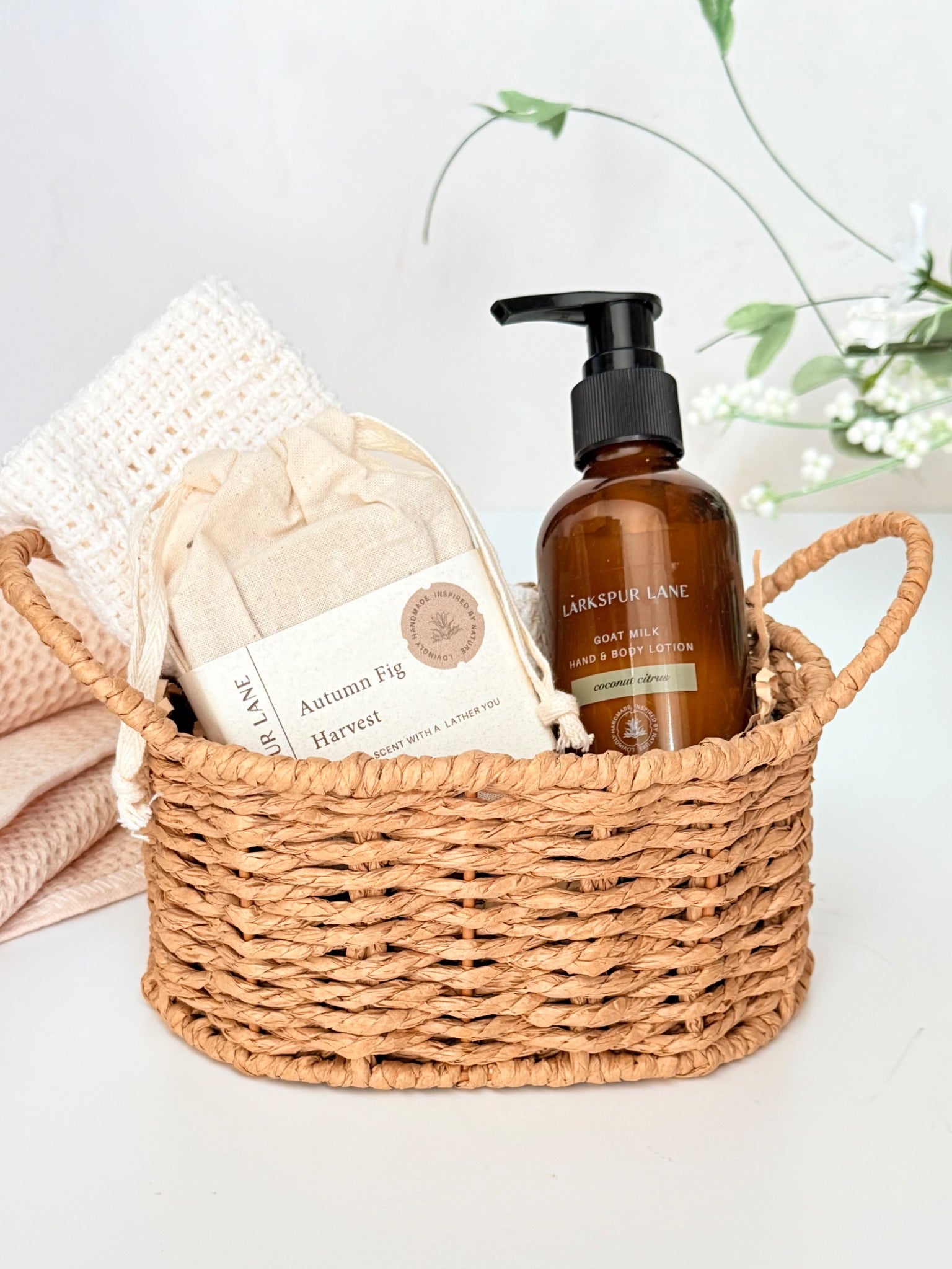 Goat milk soap and lotion gift basket with 4 oz lotion, handcrafted soap and cotton washcloth in a woven basket.